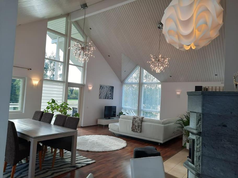 a living room with a table and a couch at Villa Kilpäkki in Pori