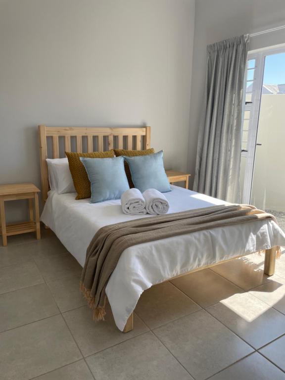 a bedroom with a large bed with towels on it at CoCo Kai Self-Catering Accommodation, Laguna Sands, Langebaan in Langebaan