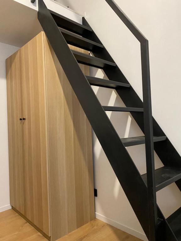 a staircase in a room with a wooden cabinet at Studio Apartment Park Zrinjevac in Zagreb