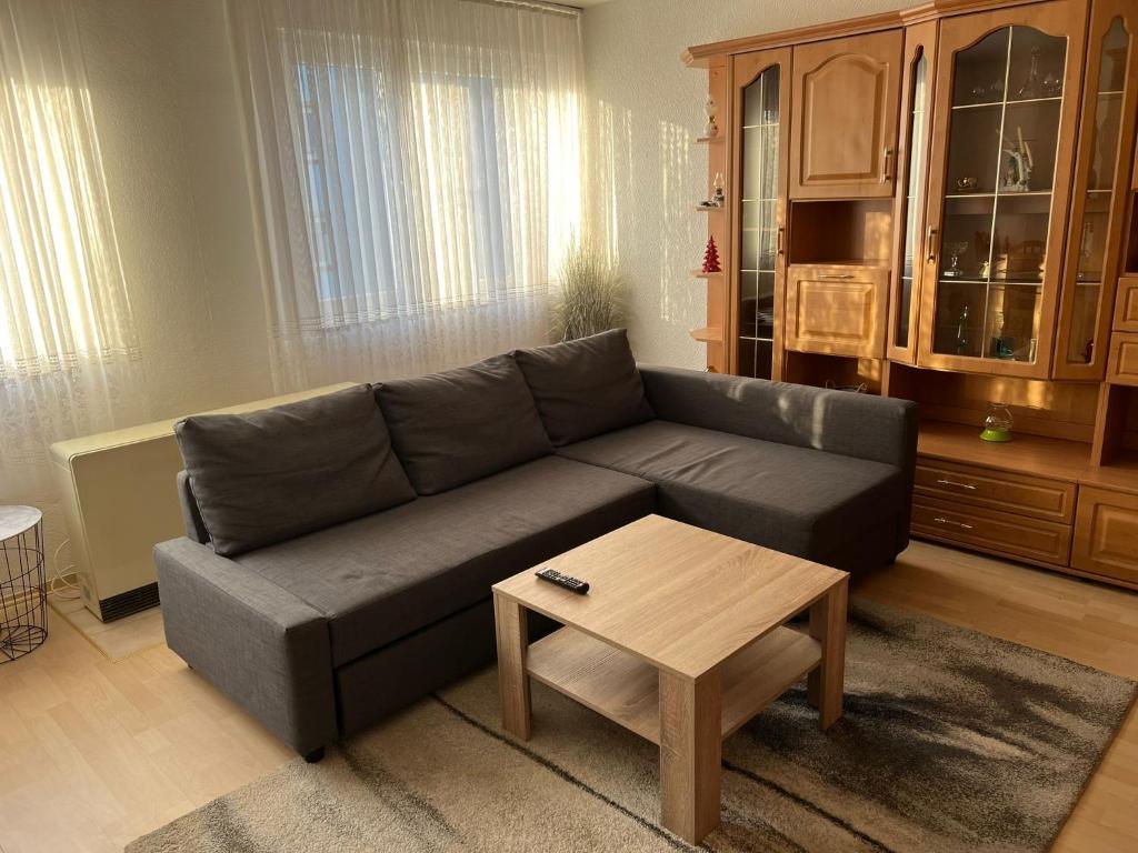 a living room with a couch and a coffee table at Schöne Ferienwohnung in Saarbrücken in Saarbrücken