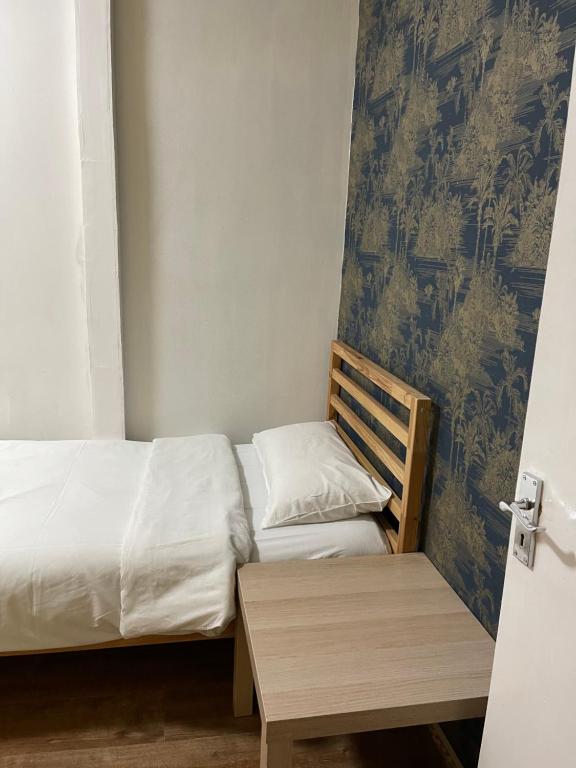 a small bedroom with two beds and a table at 03 Bedroom Apartment-Self Check in in London