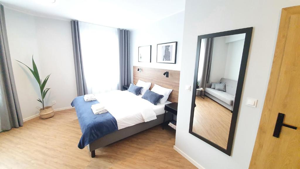 a bedroom with a bed and a mirror at Sleep Port in Gdańsk