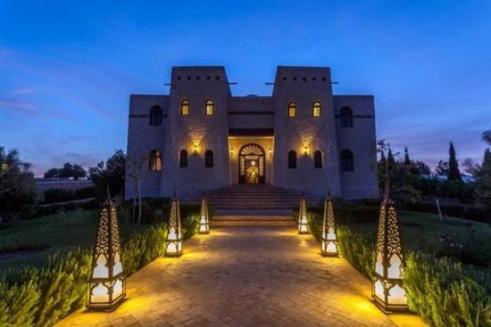 a large building with lights in front of it at Charmante Villa Riad Dharma in Essaouira