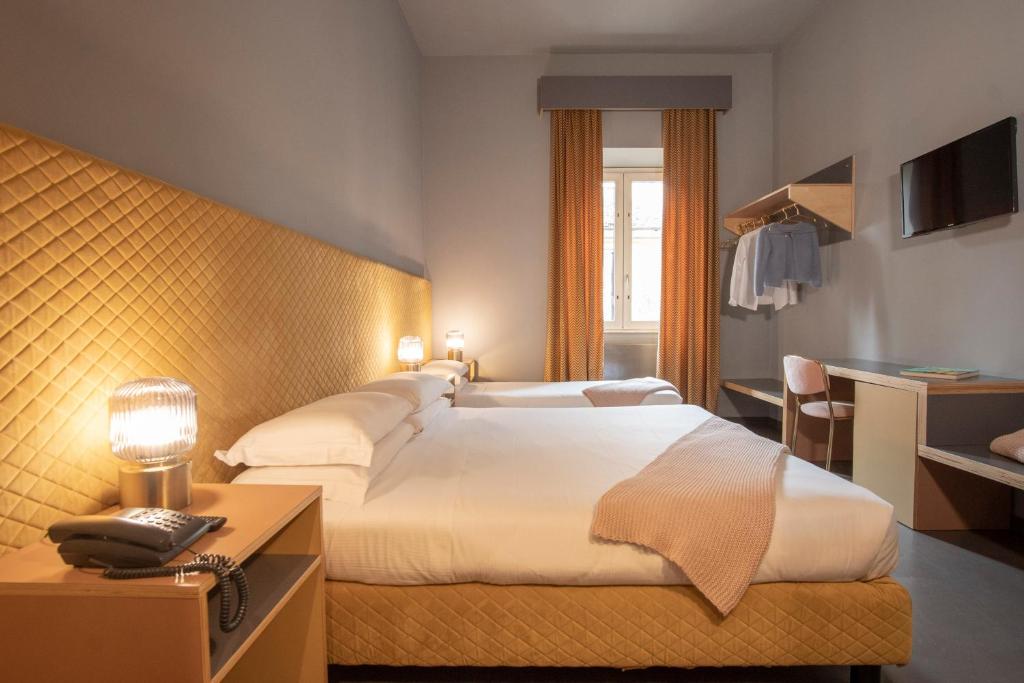 Postel nebo postele na pokoji v ubytování Hotel Milani