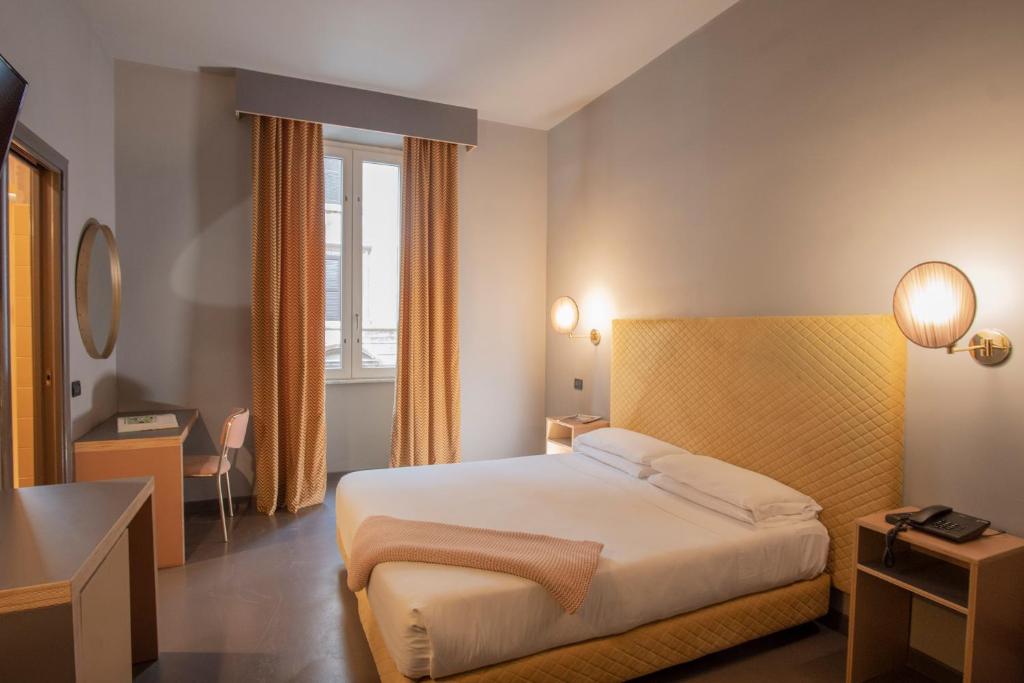 Postel nebo postele na pokoji v ubytování Hotel Milani