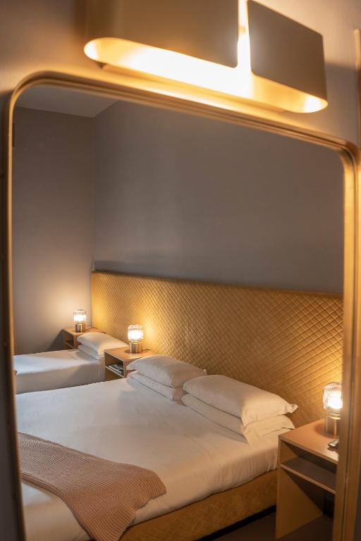 Postel nebo postele na pokoji v ubytování Hotel Milani