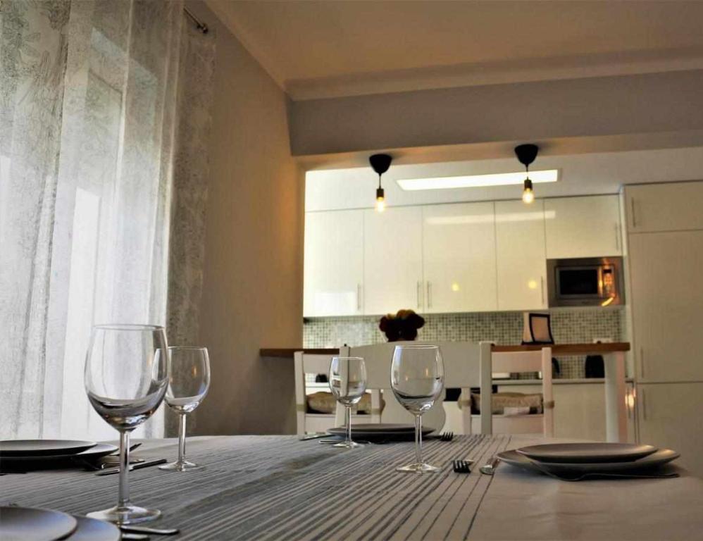 a table with wine glasses sitting on top of it at AlgarveSand Carvoeiro in Carvoeiro