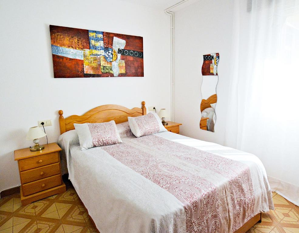 a bedroom with a bed and a painting on the wall at Apartamentos Caleiro 4P - Vilanova de Arousa in Villanueva de Arosa