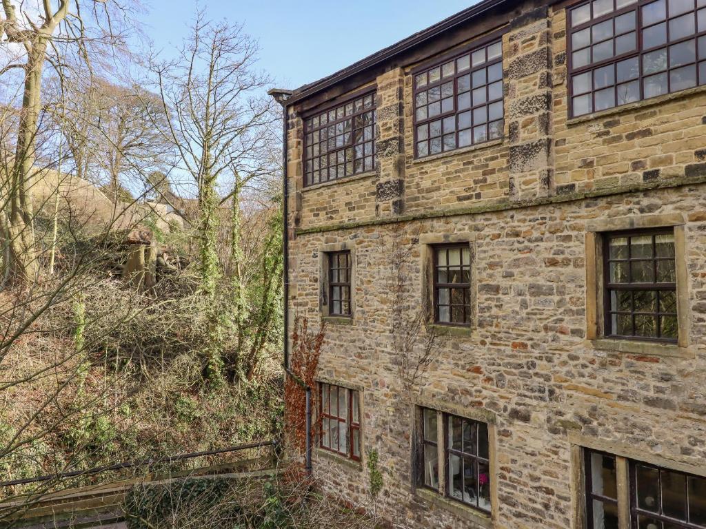 an old brick building with windows on the side of it at The Eller Beck in Skipton