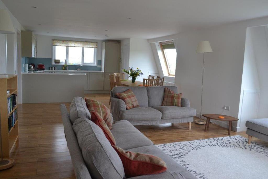 a living room with a couch and a kitchen at Keith View, Humbie Hub in Humbie