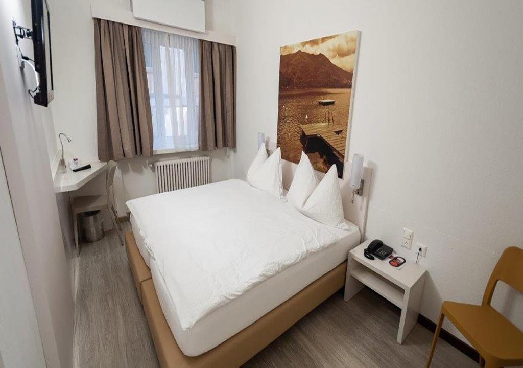 Letto o letti in una camera di Acquarello Swiss Quality Hotel
