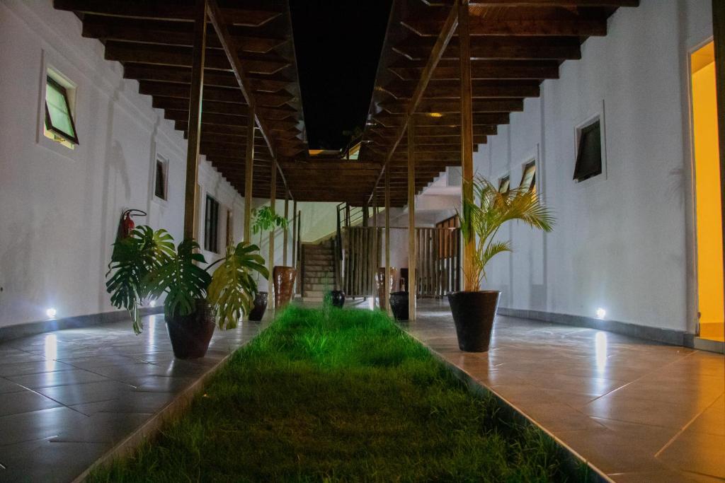 a hallway with potted plants in a building at Distinction Gardens in Siaya