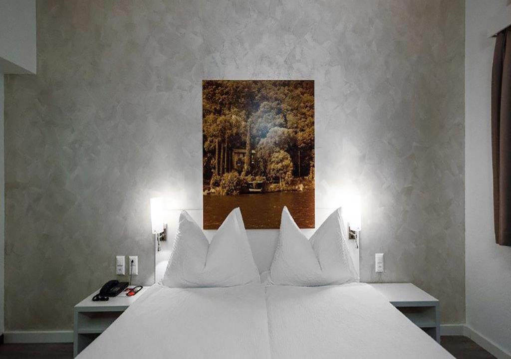 Letto o letti in una camera di Acquarello Swiss Quality Hotel