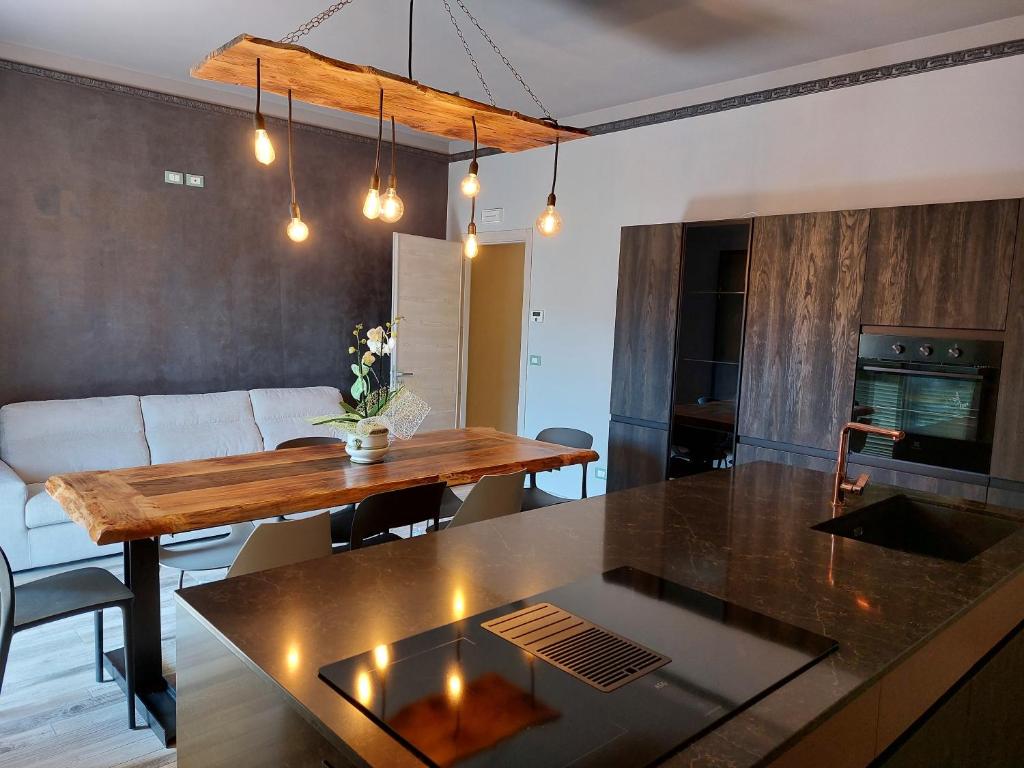 a kitchen and living room with a table and a couch at IL NIDO TRA GLI ULIVI in Lucinasco