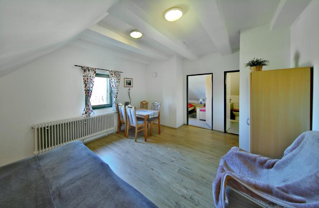 a living room with a table and chairs in it at Penzion Kairos in Klokočí
