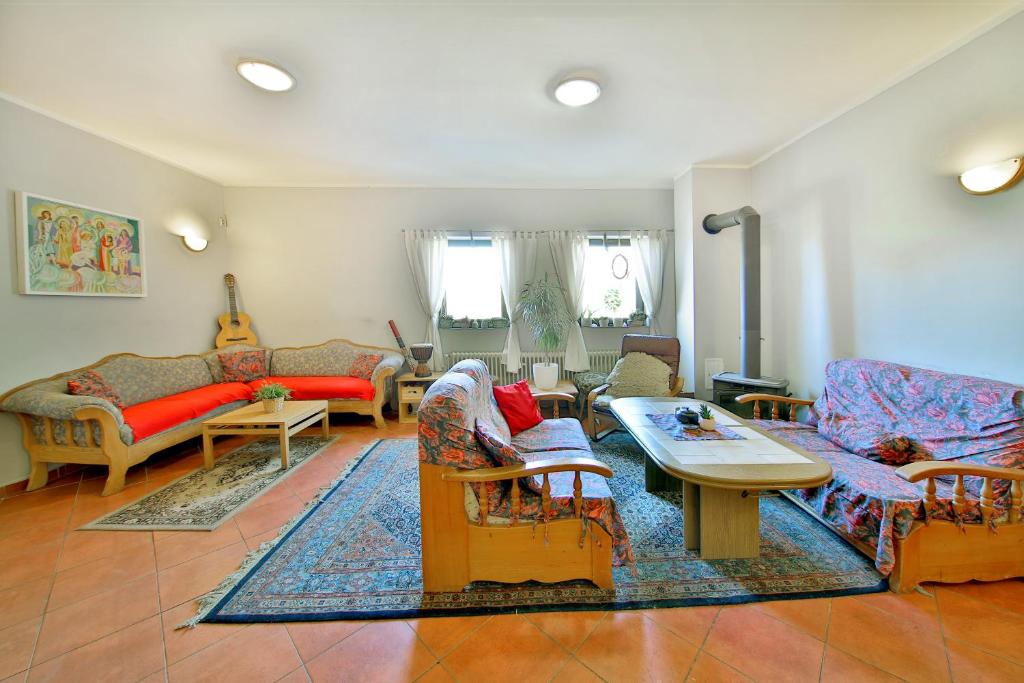 a living room with couches and a table at Penzion Kairos in Klokočí