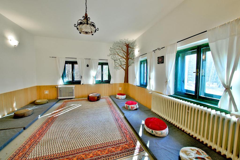 a living room with a rug on the floor at Penzion Kairos in Klokočí