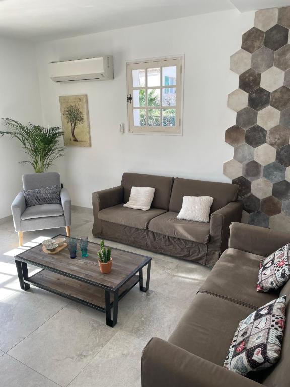 ein Wohnzimmer mit zwei Sofas und einem Couchtisch in der Unterkunft Villa Andrée avec piscine à proximité de la mer in Saint-Cyr-sur-Mer