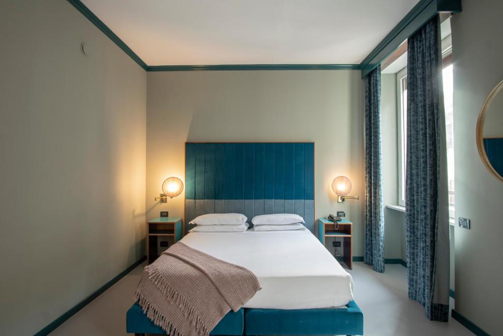 Postel nebo postele na pokoji v ubytování Hotel Milani