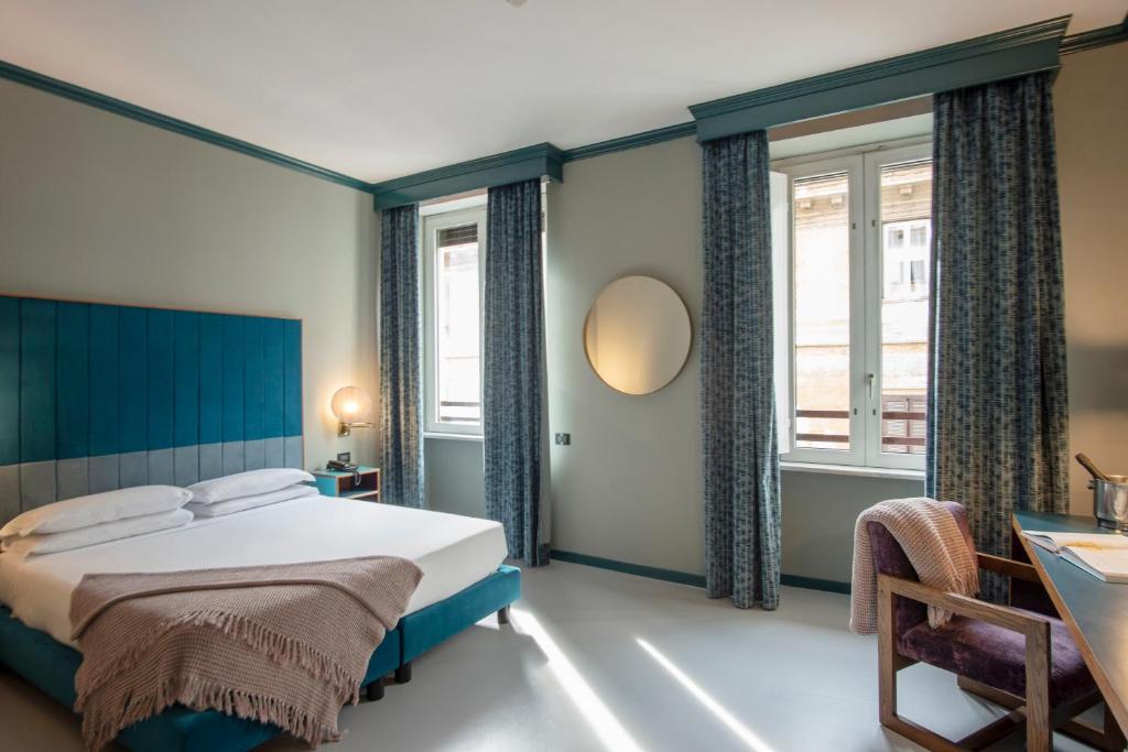 Postel nebo postele na pokoji v ubytování Hotel Milani