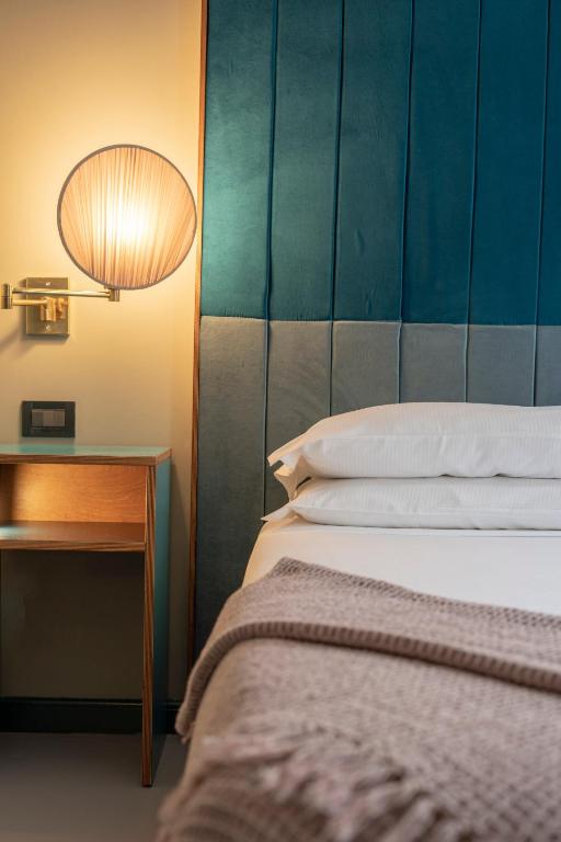 Postel nebo postele na pokoji v ubytování Hotel Milani