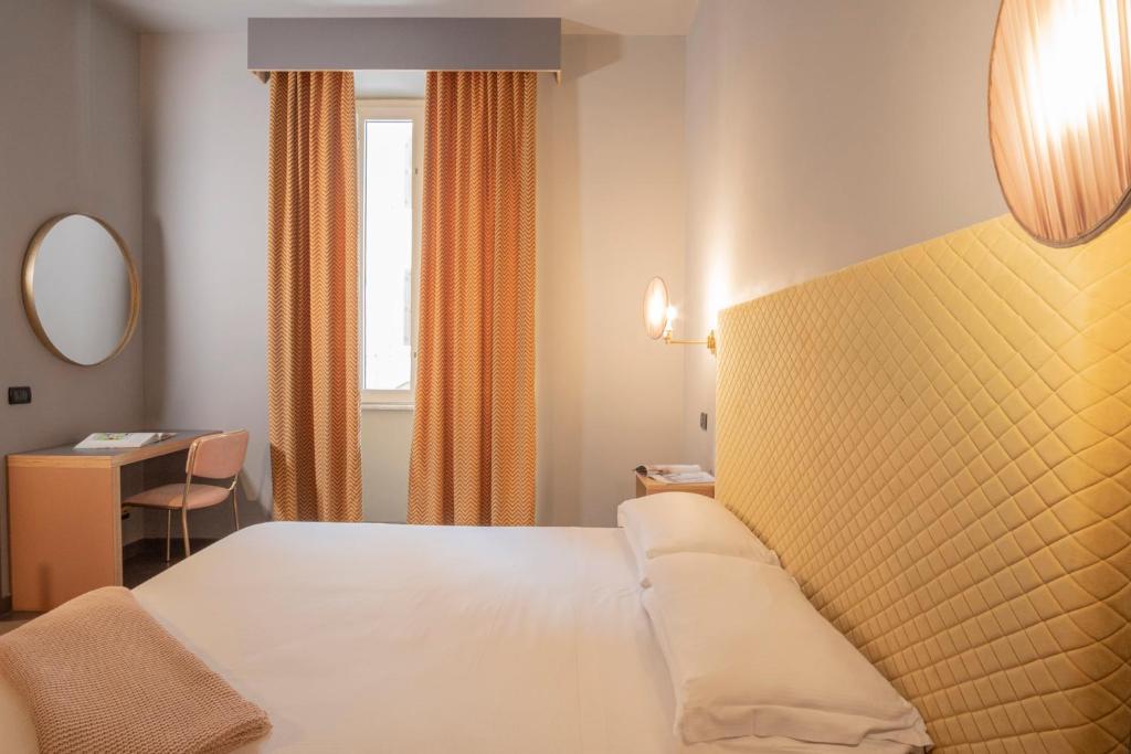 Postel nebo postele na pokoji v ubytování Hotel Milani