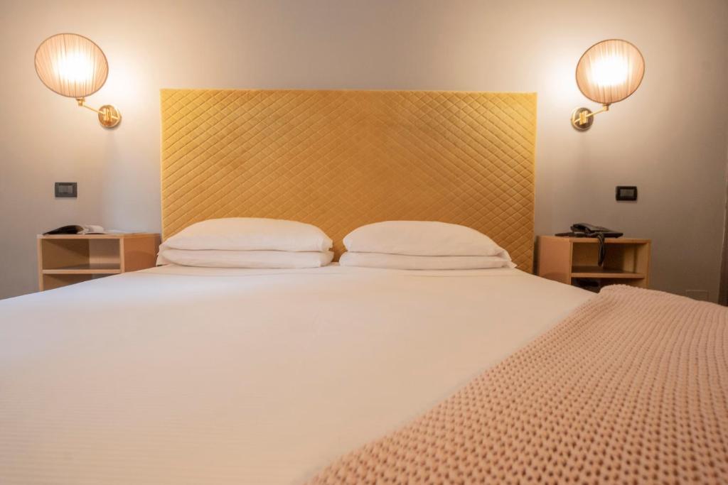 Postel nebo postele na pokoji v ubytování Hotel Milani