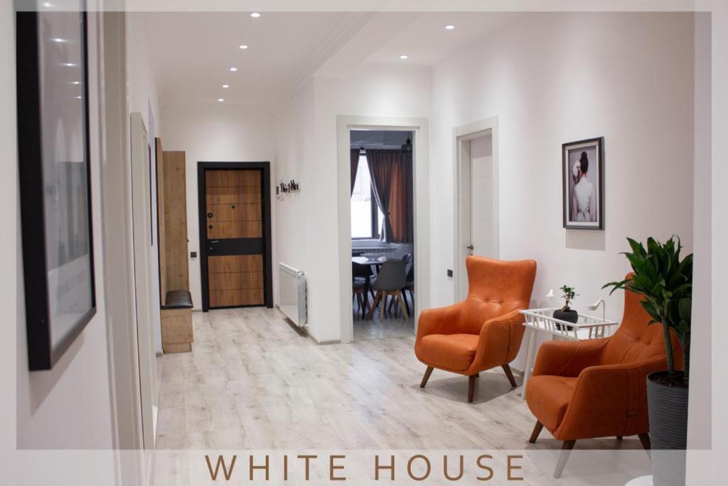 a living room with two chairs and a white house at White House in Tbilisi City
