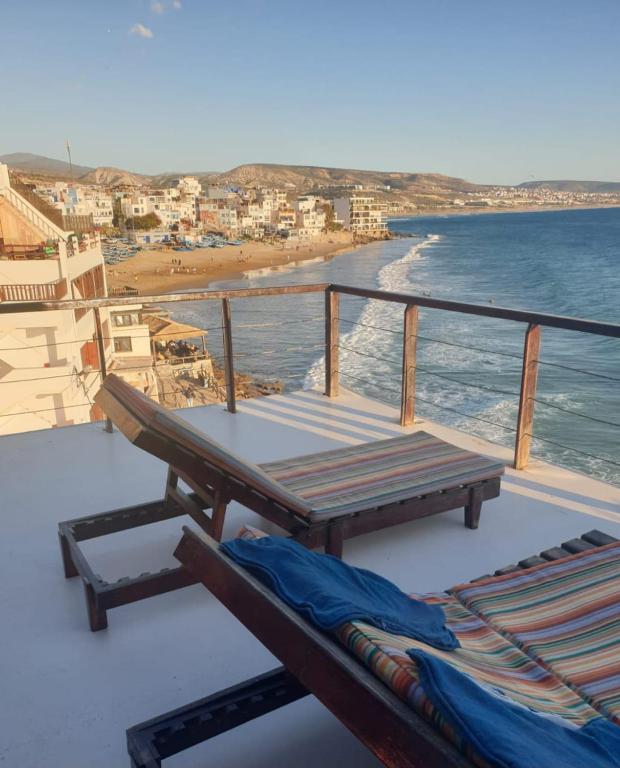 a balcony with a picnic table and a view of the beach at Balcon sur l'ocean in Taghazout