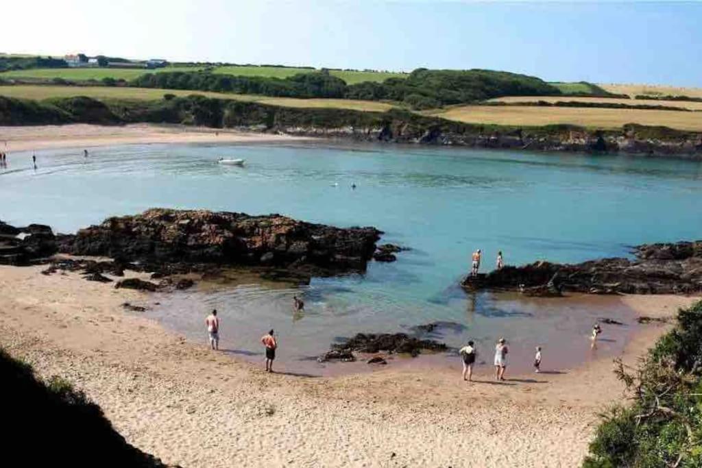 a group of people standing on a beach at Pembrokeshire Near Beach With A Hot Tub in Pembroke