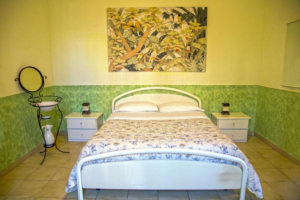 1 dormitorio con 1 cama y una pintura en la pared en Arabona B&B, en Sulmona