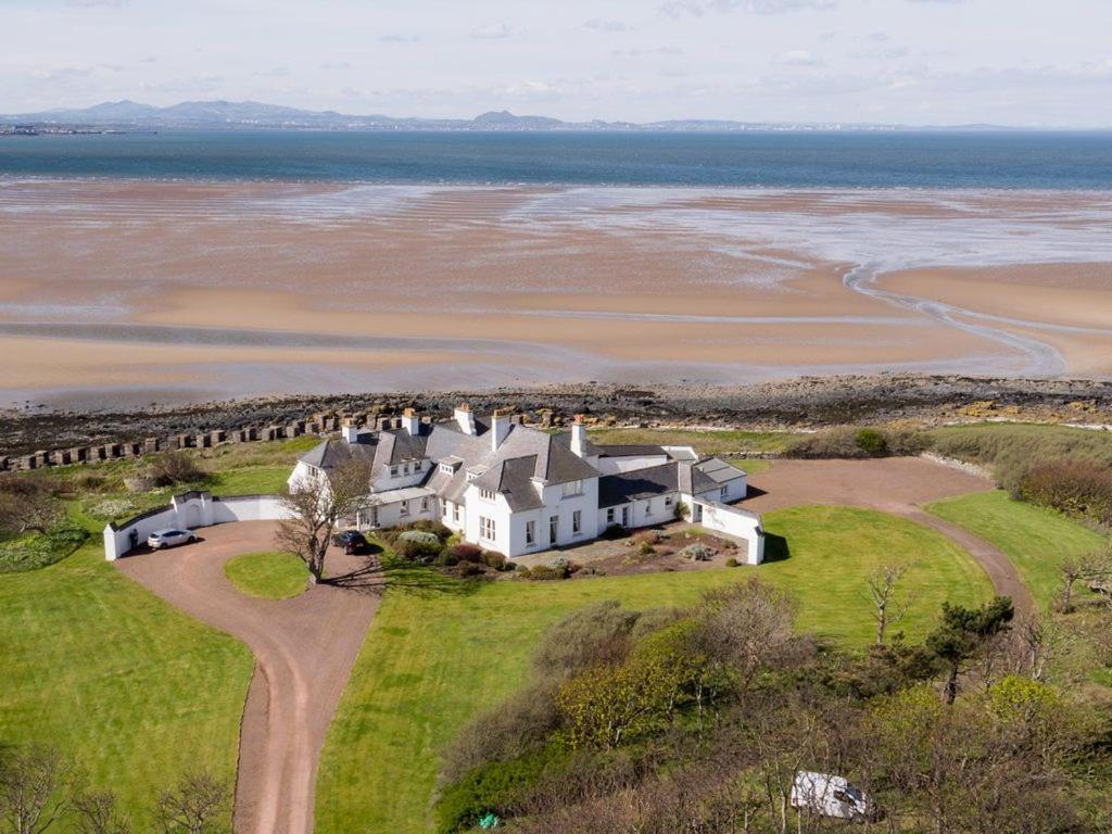 an aerial view of a large house on the beach at Green Craig in Aberlady