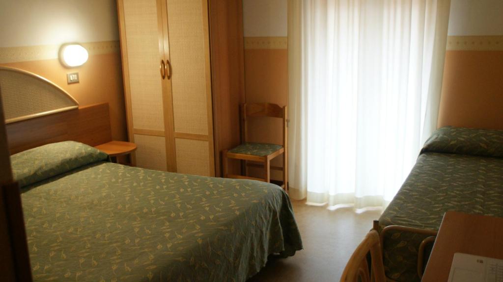 Postel nebo postele na pokoji v ubytování Hotel Verudella