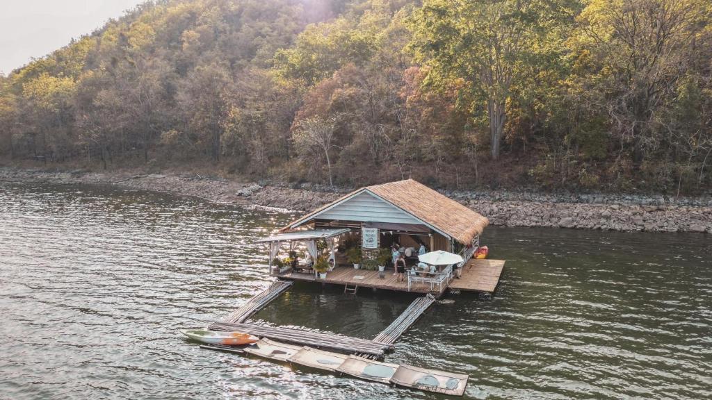 a small house on a dock in the water at Hometown Riverview - โฮมทาวน์ ริเวอร์วิว in Si Sawat