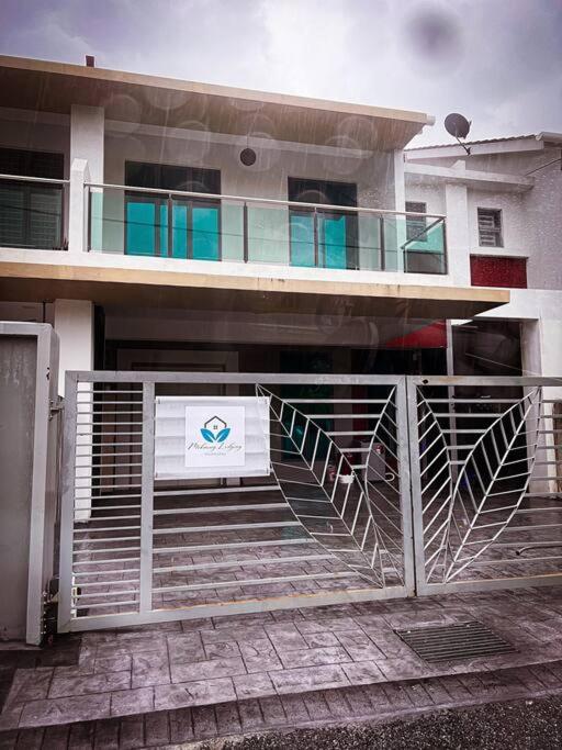a building with a gate in front of it at Mekming Lodging - Homestay in Melaka