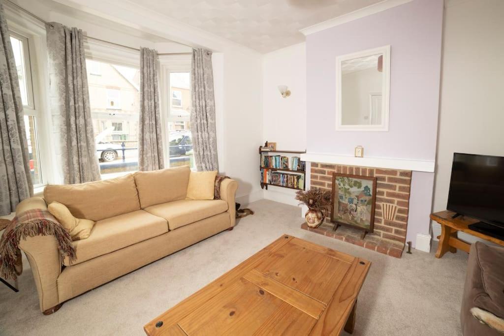 a living room with a couch and a fireplace at Yarborough in East Cowes