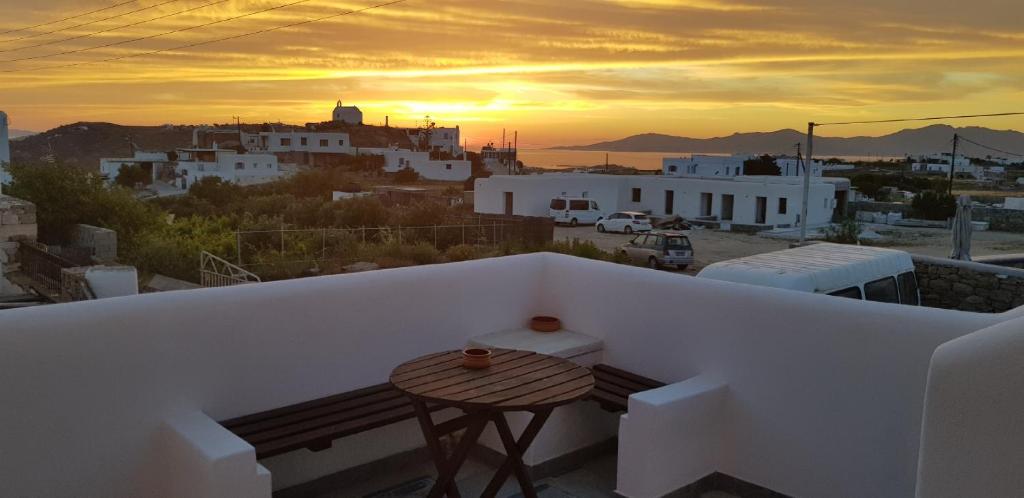 a balcony with a table and a view of a city at Hotel Kastelakia Mykonos in Mýkonos City