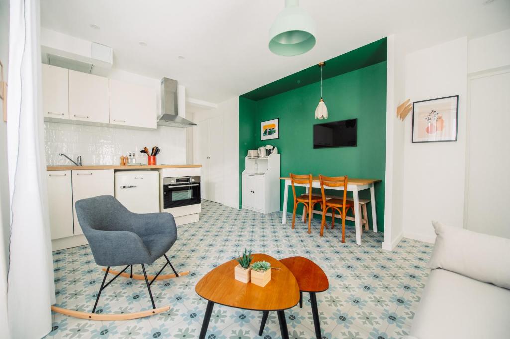eine Küche und ein Wohnzimmer mit einem Tisch in der Unterkunft Casita - Comme une petite maison - Parking gratuit in Valence
