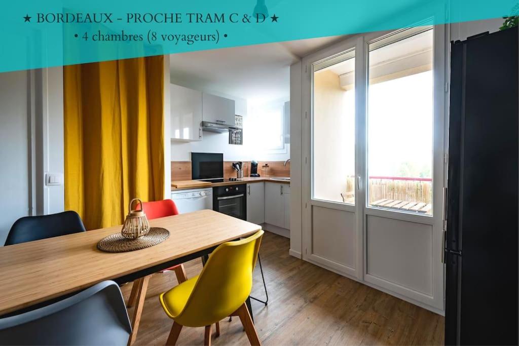 a kitchen with a wooden table and yellow chairs at Life&Travel - Appartement Bordeaux - 4 chambres in Bordeaux