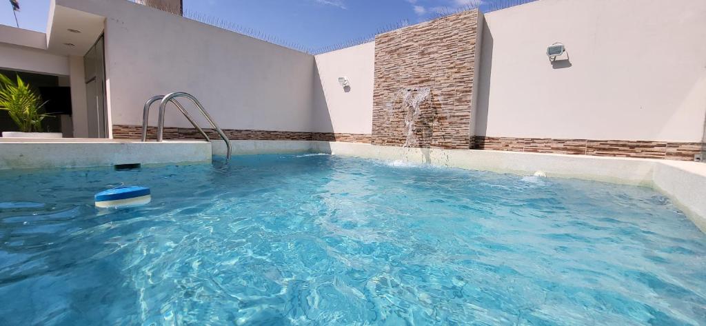 a swimming pool in the middle of a house at L & P Apart Punta Hermosa in Punta Hermosa