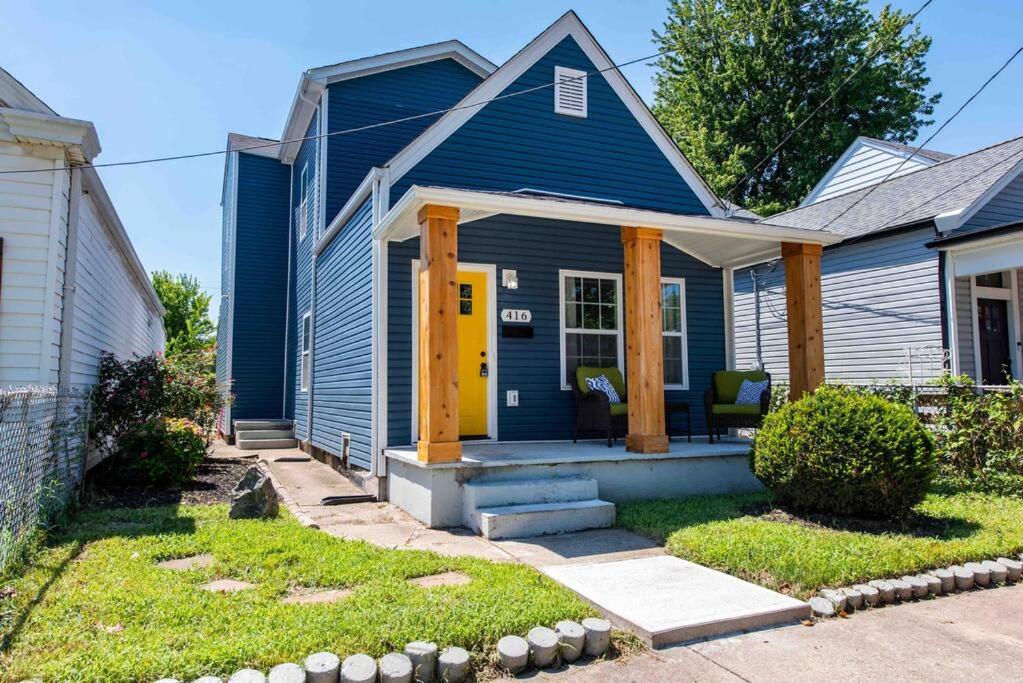 a blue house with a yellow door at Newly Renovated 3 Bedroom Shelby Park Home **FREE PARKING** in Louisville