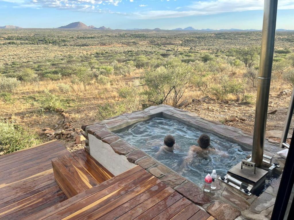 two people in a hot tub in the desert at LEOPARD'S VIEW MOUNTAIN VILLA @ Steinheim Game Farm & Camping in Prospect