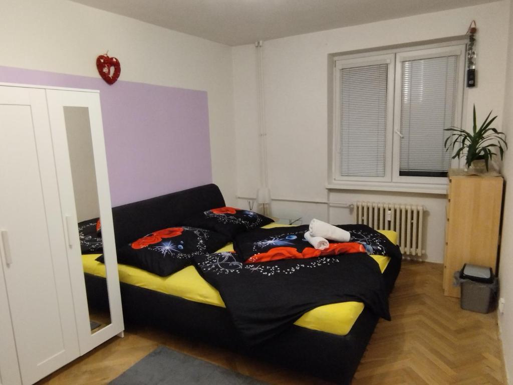 a bedroom with two beds and a mirror at apartmán Mirabella in Královo Pole