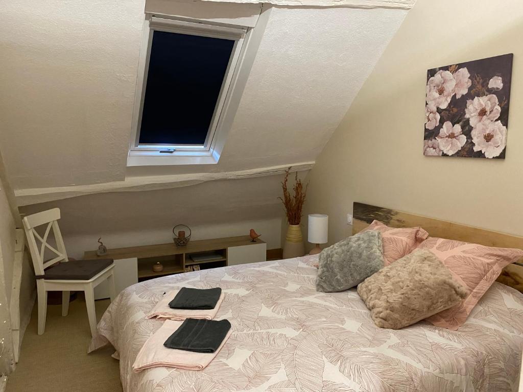 a bedroom with a bed with a window and a desk at L'éloge de Vouvray, Orbois in Vouvray