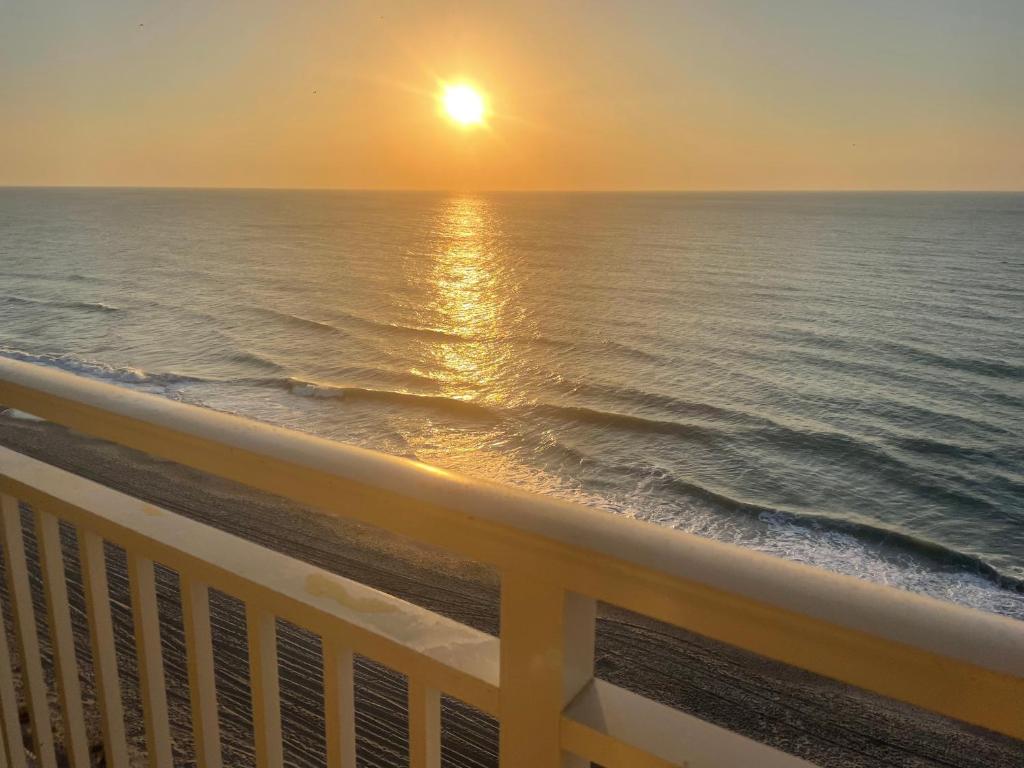 a view of the ocean at sunset from a balcony at Sunset Seaview-21103 in Myrtle Beach