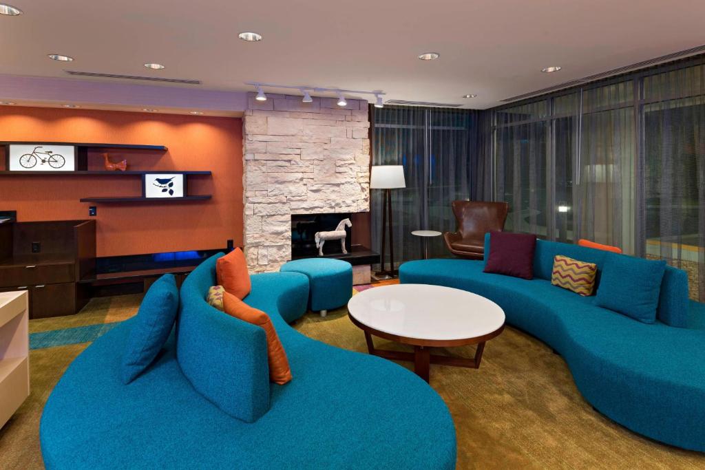 a living room with blue furniture and a fireplace at Fairfield Inn & Suites by Marriott Dublin in Dublin