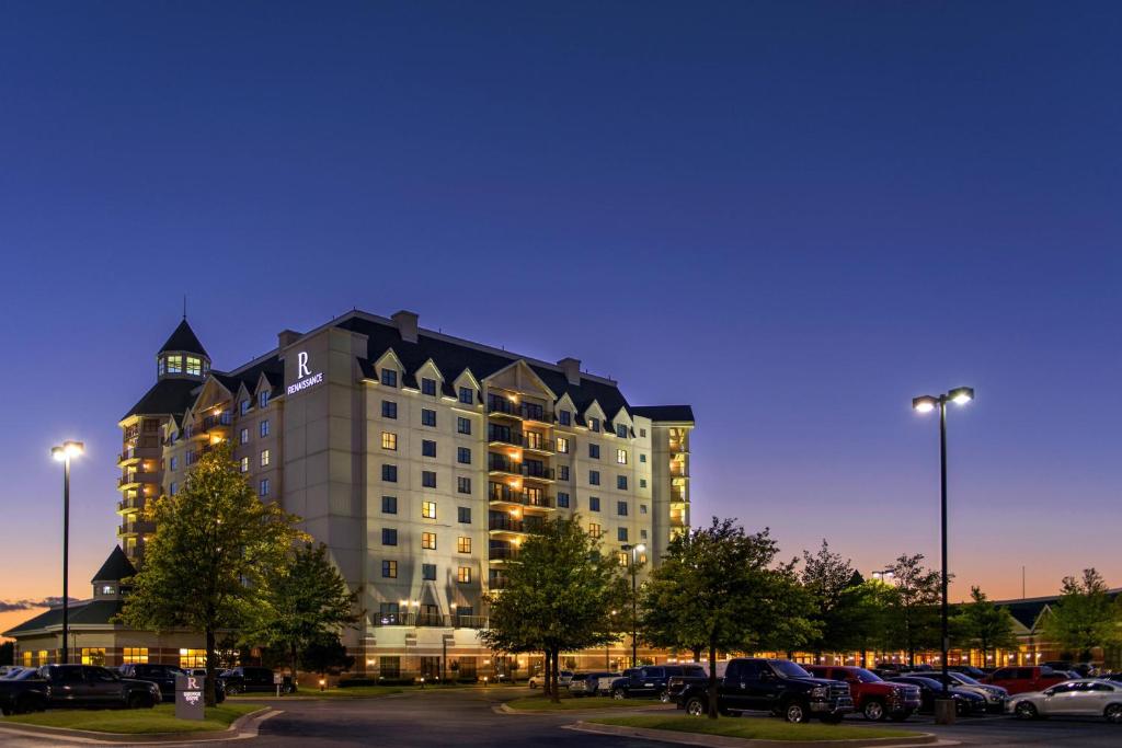 a large building with cars parked in a parking lot at Renaissance Tulsa Hotel & Convention Center in Tulsa