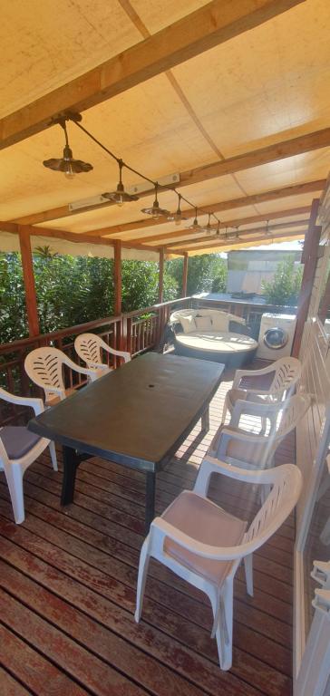 a table and chairs on the deck of a boat at Mobil home MAXI CONFORT SUR LA COTE D'AZUR in Fréjus