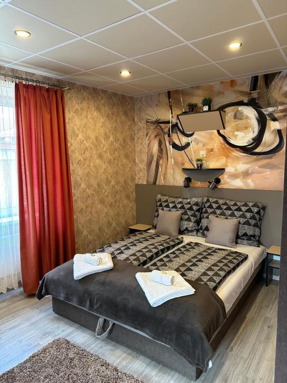 A bed or beds in a room at Demizson Vendégház