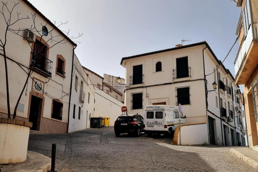 a car parked in a street next to a building at Casa Hidalgo in Baena